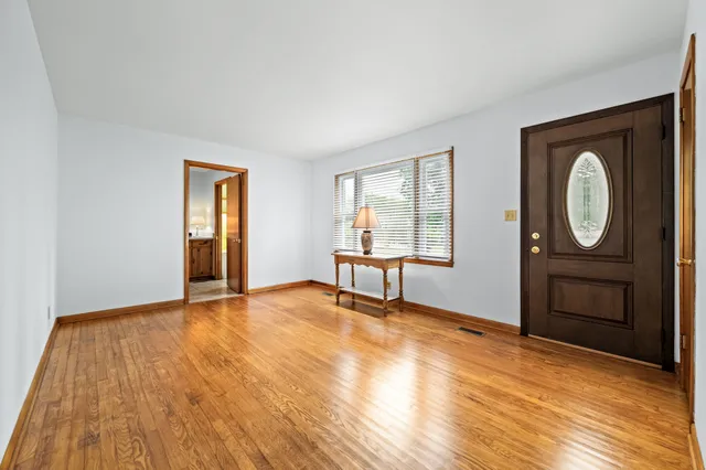 a view of a livingroom with wooden floor and a fireplace