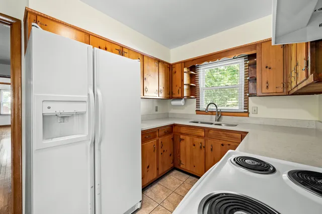 a kitchen with a refrigerator and a sink