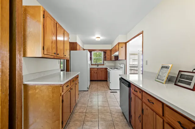 a kitchen with stainless steel appliances granite countertop a sink and cabinets