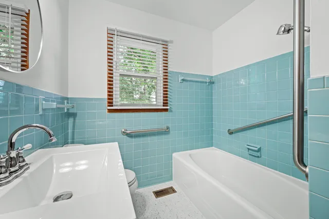 a bathroom with a sink a toilet and tub