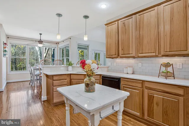 a kitchen with stainless steel appliances granite countertop counter space a sink cabinets and wooden floor