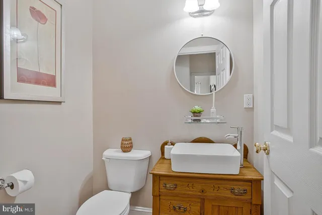 a bathroom with a toilet a sink and mirror