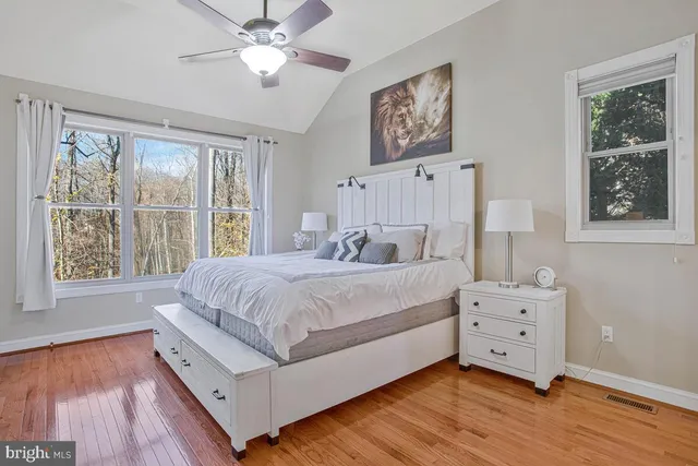 a spacious bedroom with a bed and a window