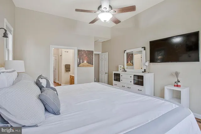 a bedroom with a bed and a flat screen tv