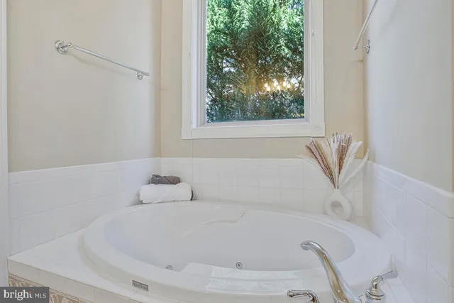 a white bath tub sitting next to a window