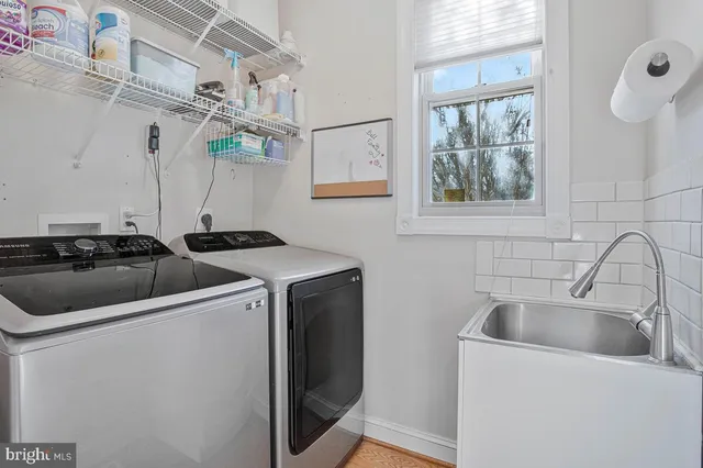 a view of a sink and dishwasher with a washer dryer