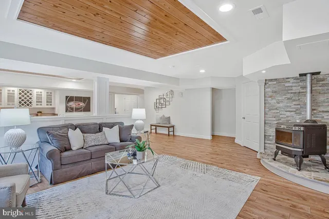 a living room with furniture wooden floor and a table