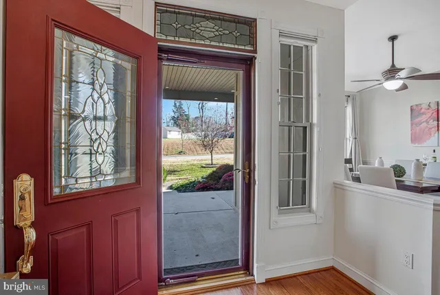 a view of a room that has a window and wooden floor