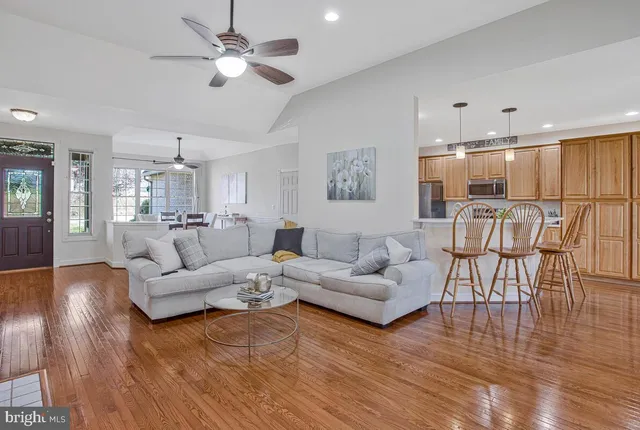 a living room with furniture and kitchen view