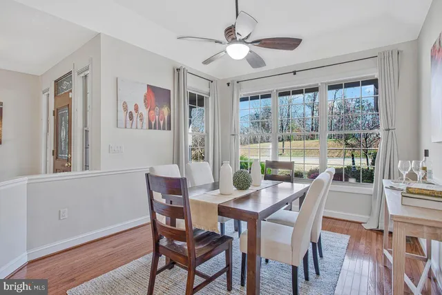 a view of a dining room with furniture large window and wooden floor