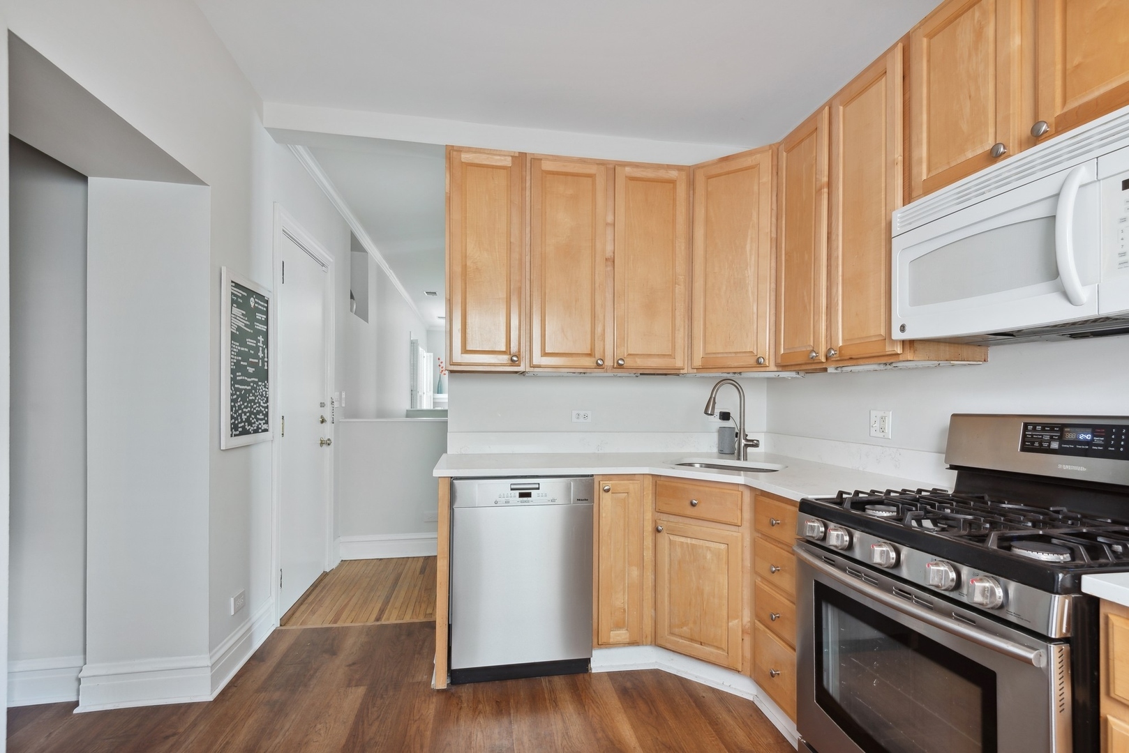 422 Hamilton Street, Unit 1 Evanston, IL 60202 - Photo 11 of 23 a kitchen with a stove a sink and a microwave