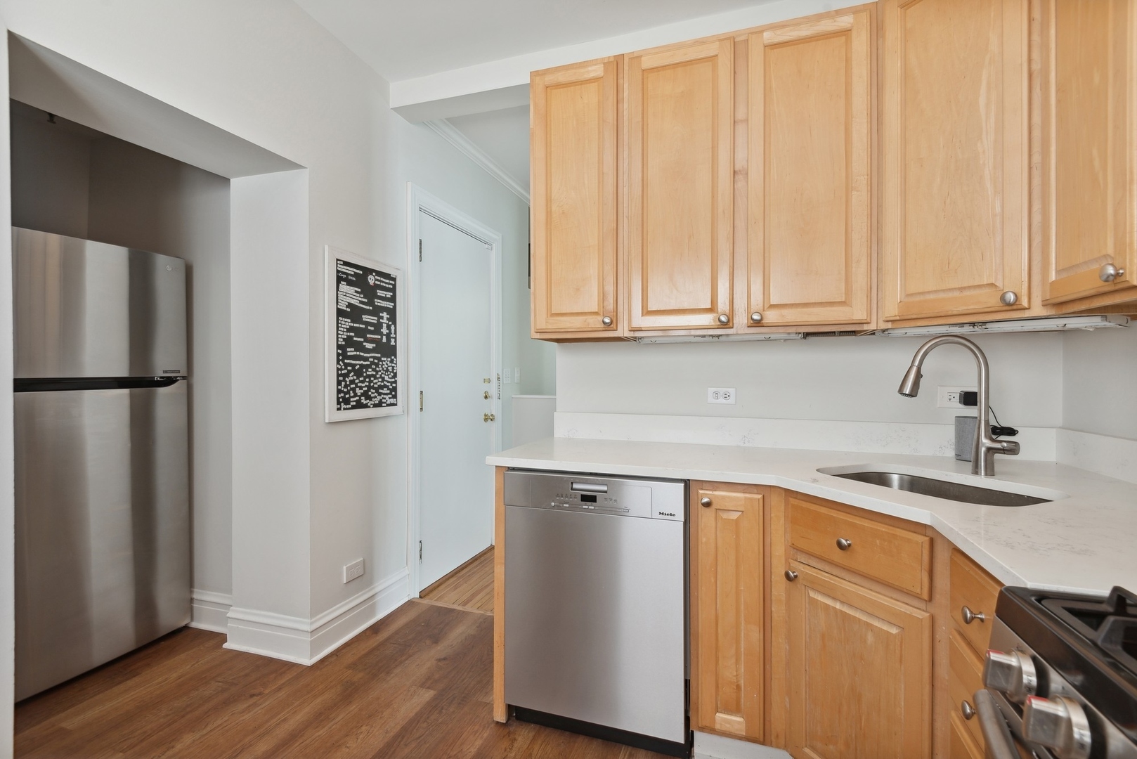 422 Hamilton Street, Unit 1 Evanston, IL 60202 - Photo 12 of 23 a kitchen with a sink cabinets and a refrigerator