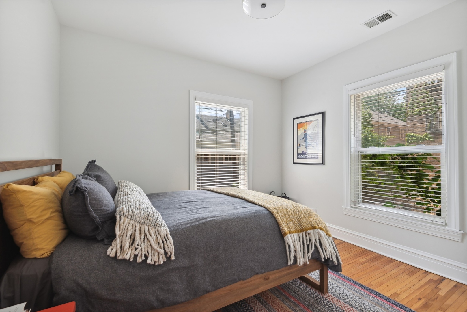 422 Hamilton Street, Unit 1 Evanston, IL 60202 - Photo 15 of 23 a bed sitting in a bedroom next to a window