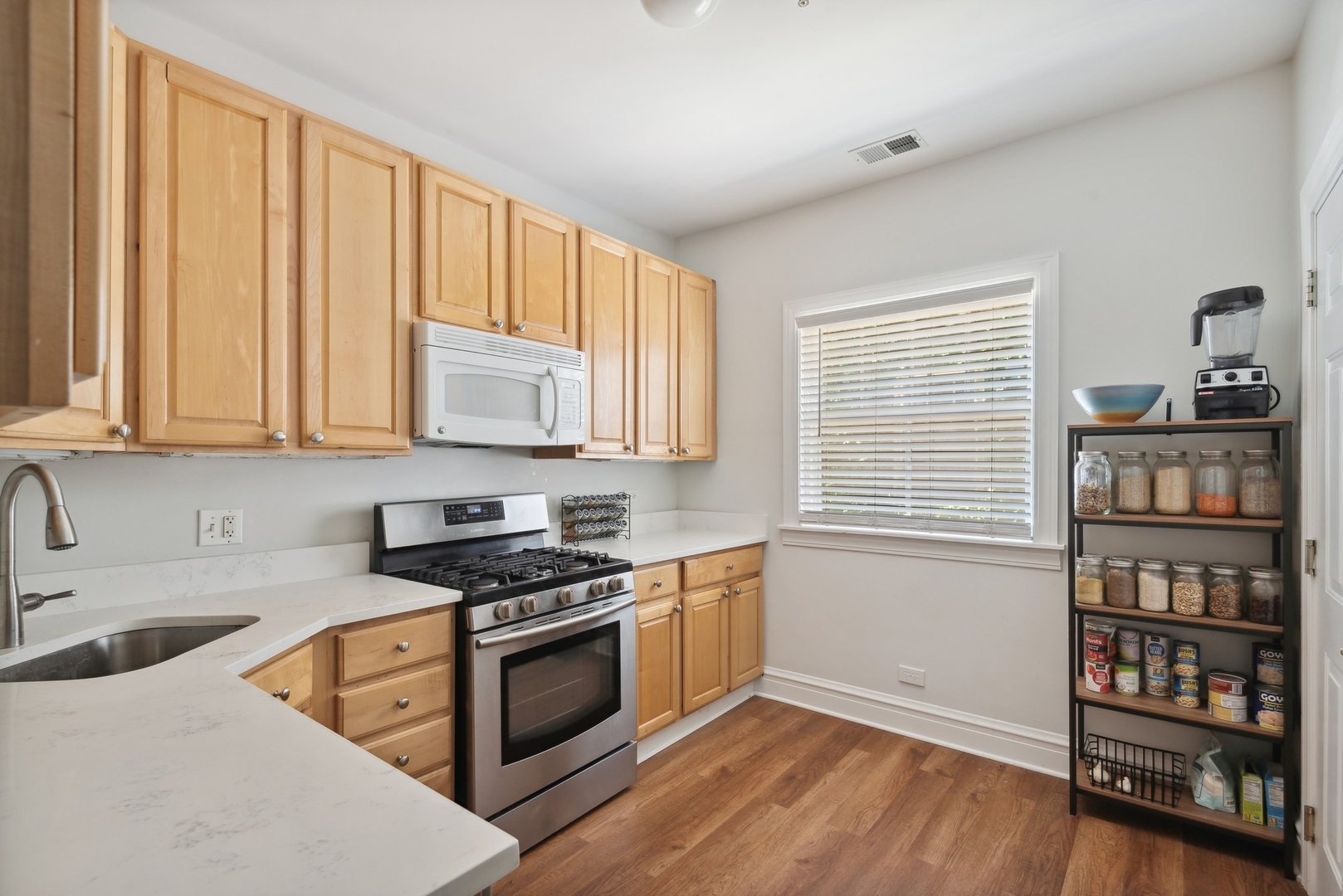 422 Hamilton Street, Unit 1 Evanston, IL 60202 - Photo 10 of 23 a kitchen with stainless steel appliances granite countertop a stove and a sink