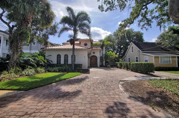 a front view of a house with a yard and a garage
