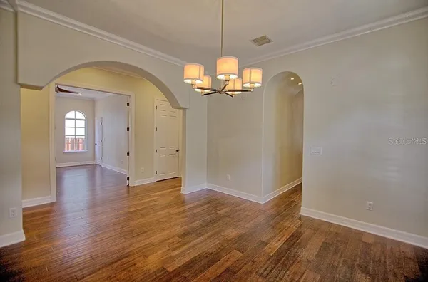 a view of a room with wooden floor