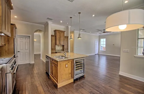 a kitchen with a stove a sink and a refrigerator