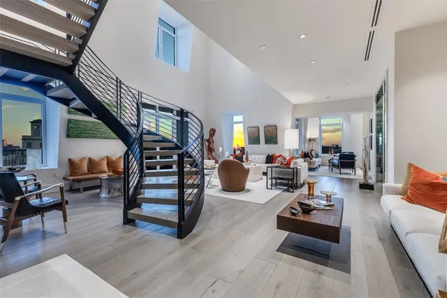 a living room with furniture and stairs