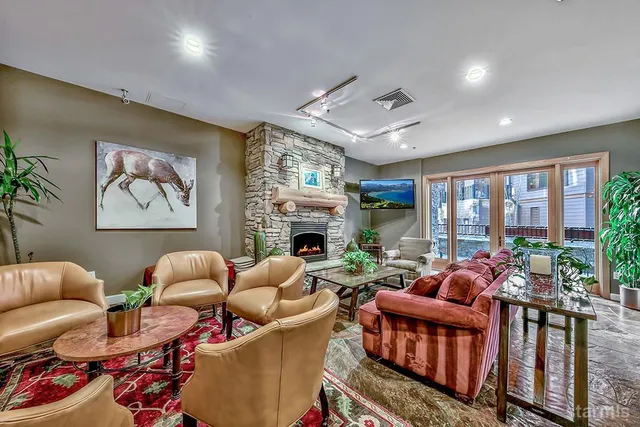 a living room with furniture fireplace and a large window