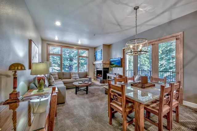 a view of a dining room with furniture large windows and wooden floor