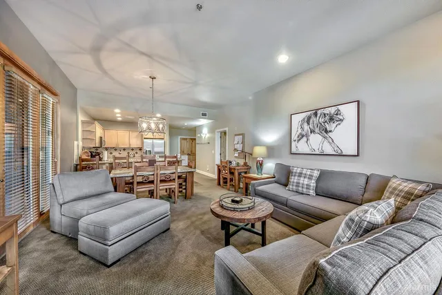 a living room with furniture and a chandelier