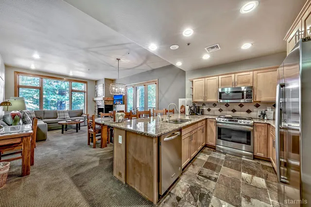 a kitchen with stainless steel appliances granite countertop lots of counter top space