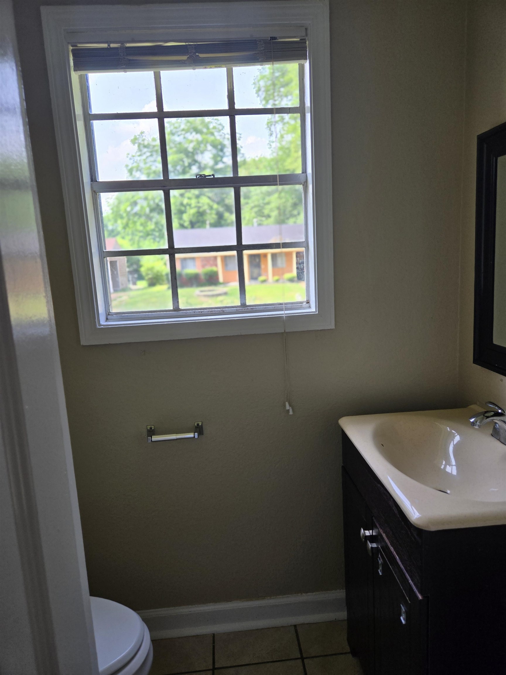 4207 Kenosha Road Memphis, TN 38118 - Photo 14 of 24 Bathroom featuring vanity, toilet, tile patterned floors, and baseboards