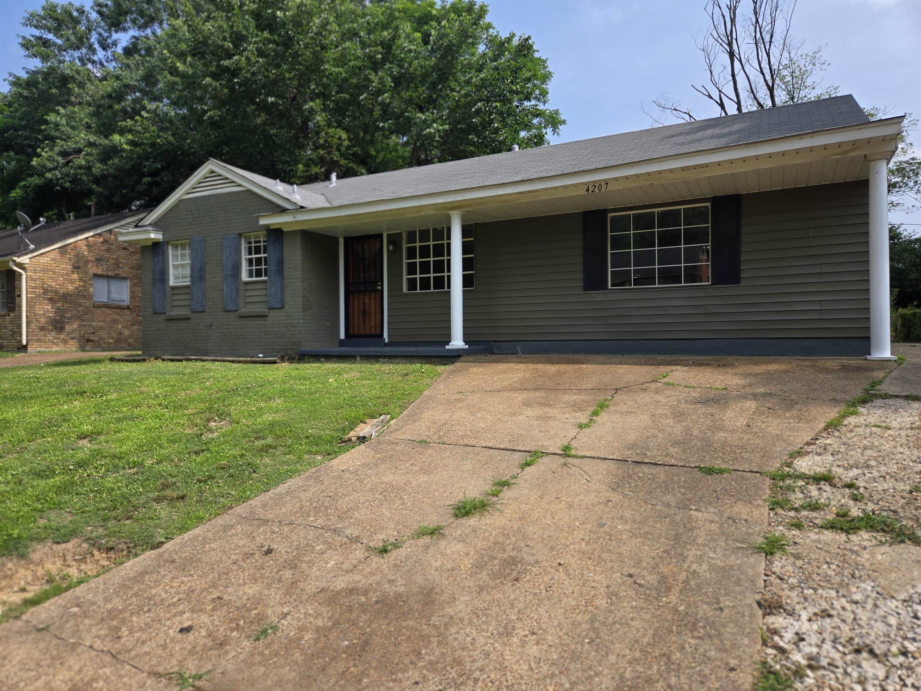 4207 Kenosha Road Memphis, TN 38118 - Photo 2 of 24 Ranch-style home featuring a front lawn, brick siding, and driveway