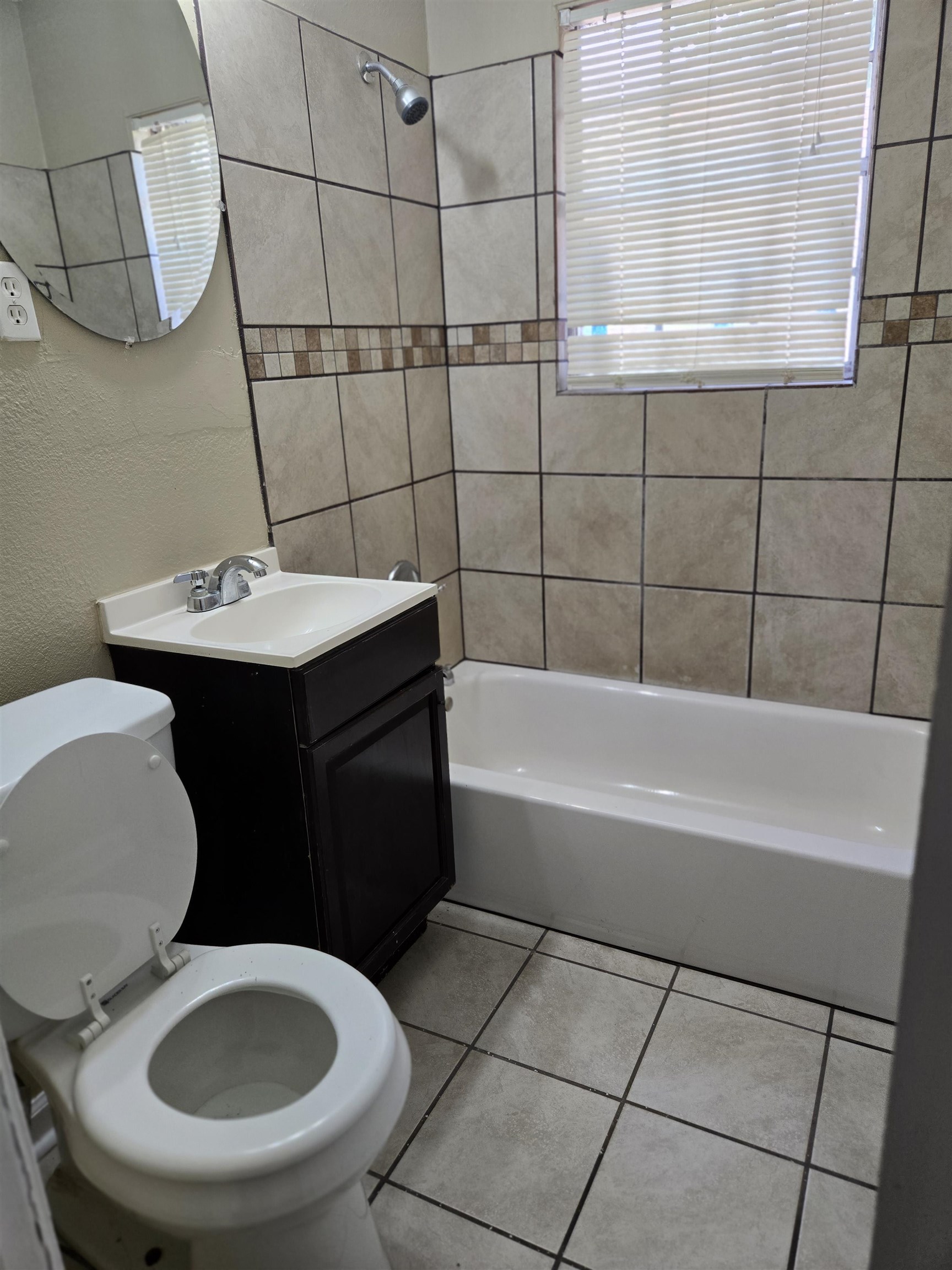 4207 Kenosha Road Memphis, TN 38118 - Photo 21 of 24 Bathroom featuring toilet, bathing tub / shower combination, tile patterned flooring, vanity, and a textured wall