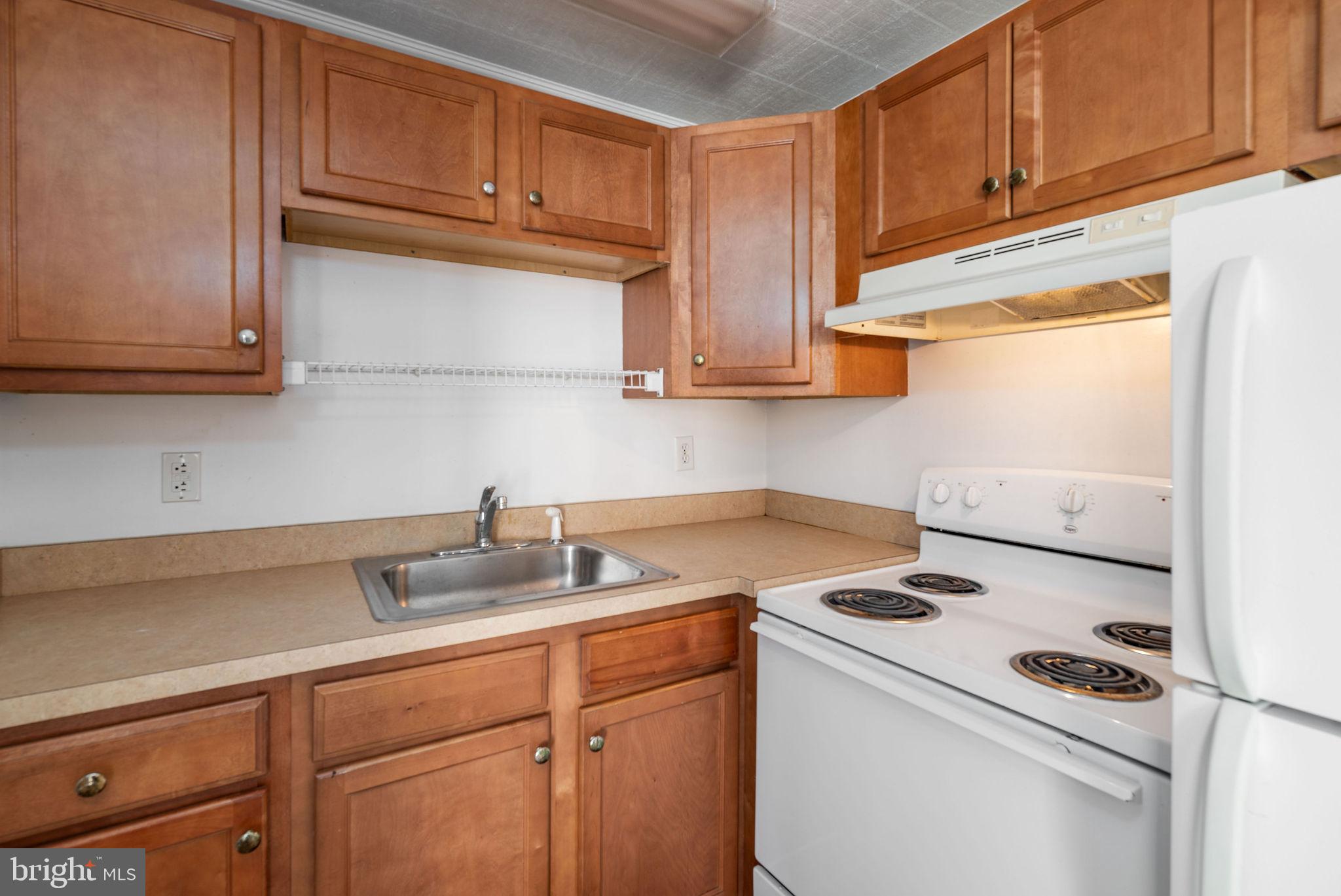 30071 Vines Creek Road Dagsboro, DE 19939 - Photo 6 of 15 a kitchen with a sink cabinets and appliances