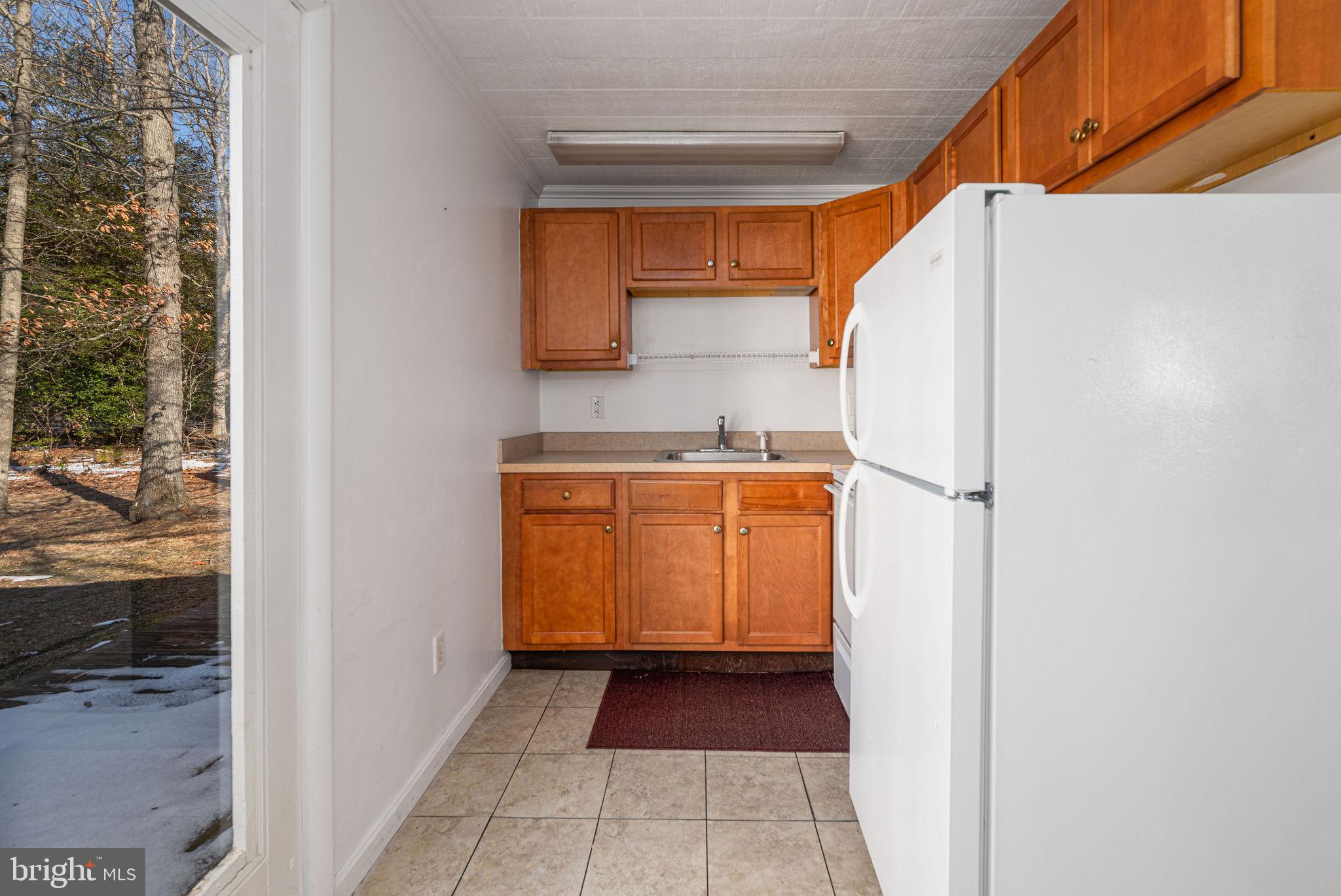 30071 Vines Creek Road Dagsboro, DE 19939 - Photo 7 of 15 a utility room with cabinets washer and dryer