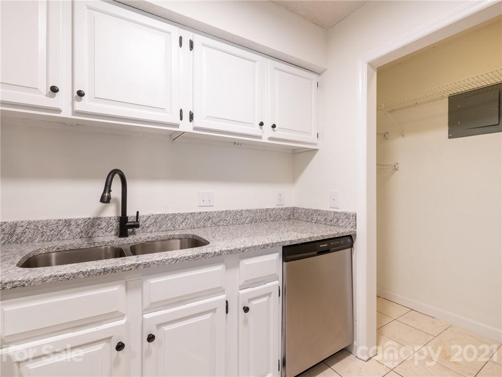 1604 Sharon Road West, Unit 24 Charlotte, NC 28210 - Photo 13 of 25 a kitchen with granite countertop a sink and cabinets