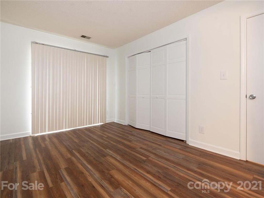 1604 Sharon Road West, Unit 24 Charlotte, NC 28210 - Photo 15 of 25 a view of an empty room with wooden floor