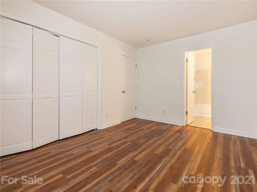 1604 Sharon Road West, Unit 24 Charlotte, NC 28210 - Photo 16 of 25 a view of an empty room with wooden floor
