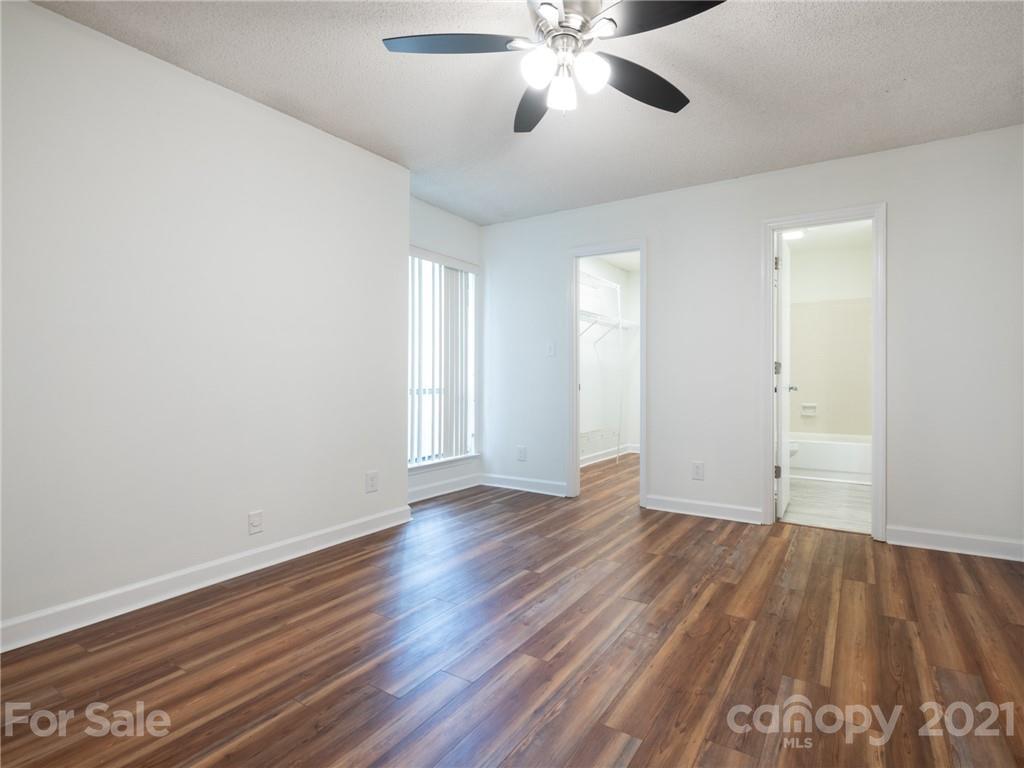 1604 Sharon Road West, Unit 24 Charlotte, NC 28210 - Photo 19 of 25 wooden floor in an empty room with a window