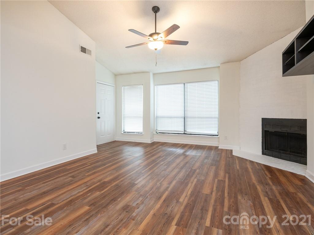 1604 Sharon Road West, Unit 24 Charlotte, NC 28210 - Photo 4 of 25 wooden floor in an empty room with a fireplace