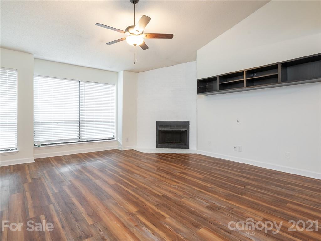 1604 Sharon Road West, Unit 24 Charlotte, NC 28210 - Photo 6 of 25 wooden floor in an empty room with a window