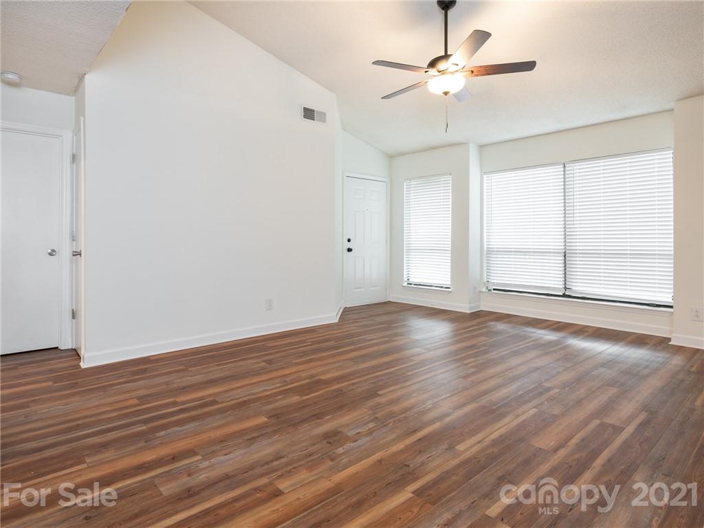 1604 Sharon Road West, Unit 24 Charlotte, NC 28210 - Photo 7 of 25 wooden floor in an empty room with a window