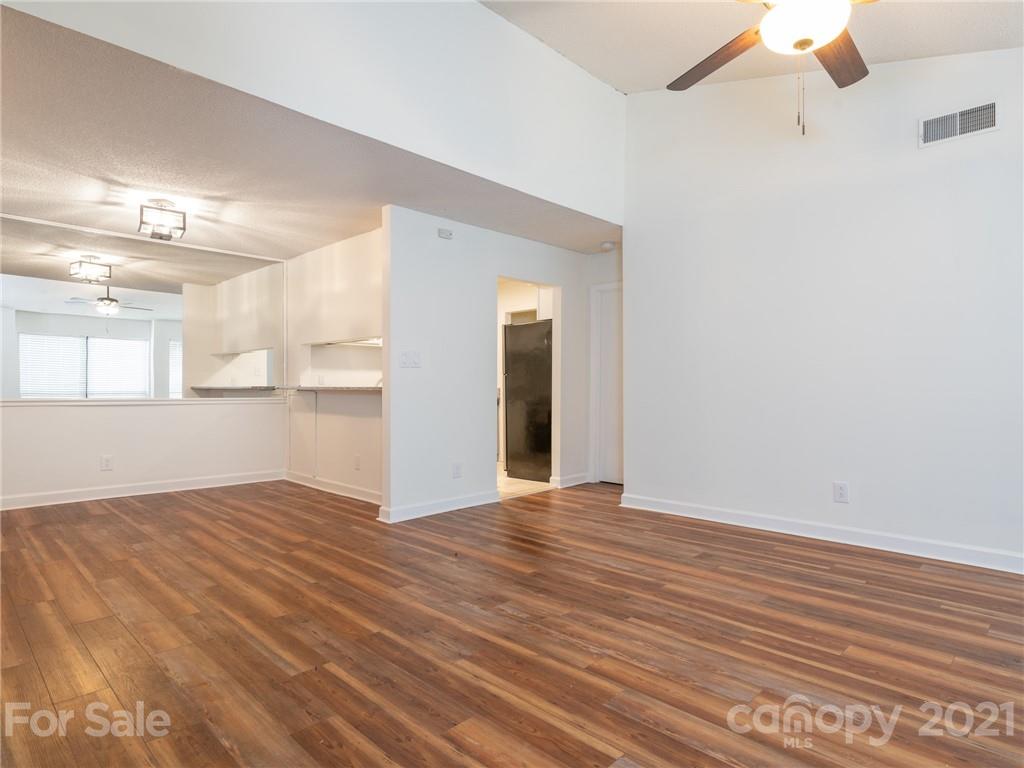 1604 Sharon Road West, Unit 24 Charlotte, NC 28210 - Photo 8 of 25 a view of wooden floor and windows in a room