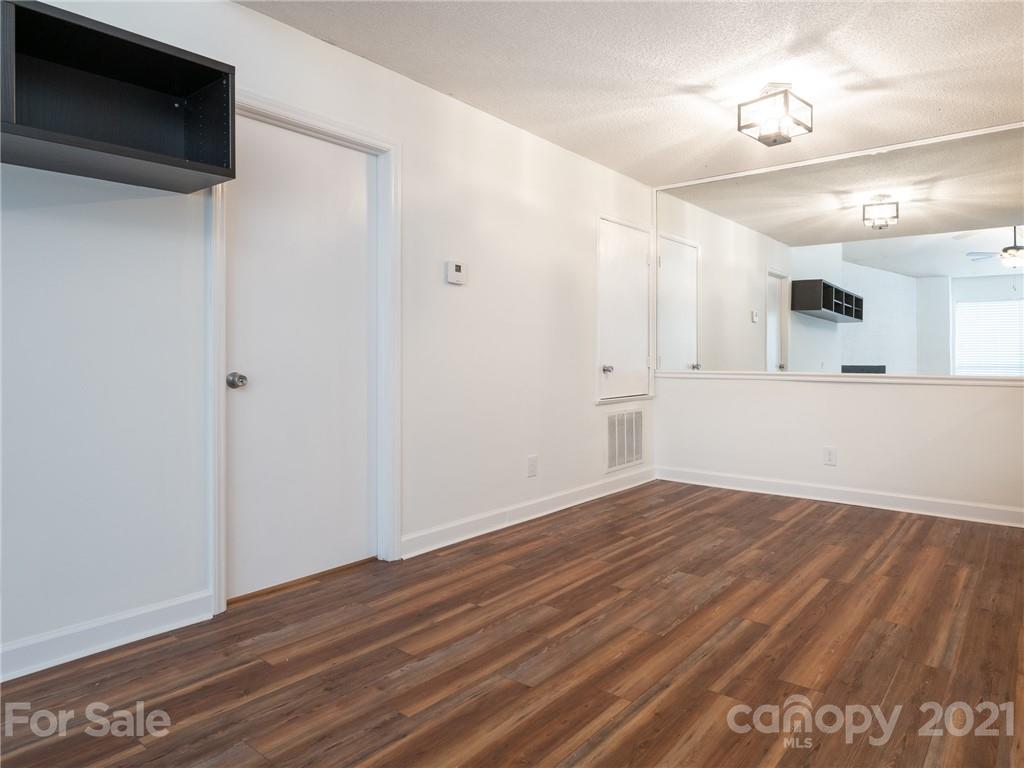 1604 Sharon Road West, Unit 24 Charlotte, NC 28210 - Photo 9 of 25 a view of empty room with wooden floor and fan