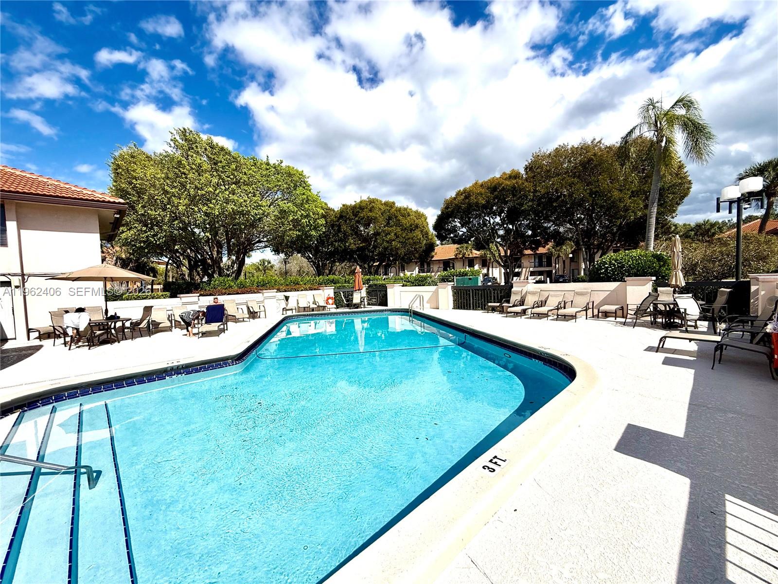 351 Club Circle, Unit 102 Boca Raton, FL 33487 - Photo 30 of 34 a swimming pool view with a outdoor seating