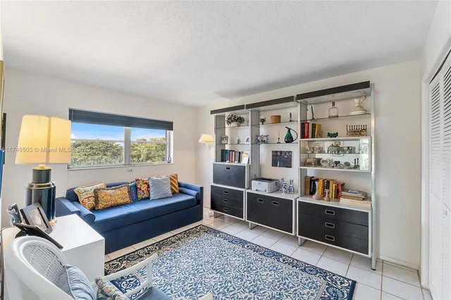 a living room with furniture and a book shelf
