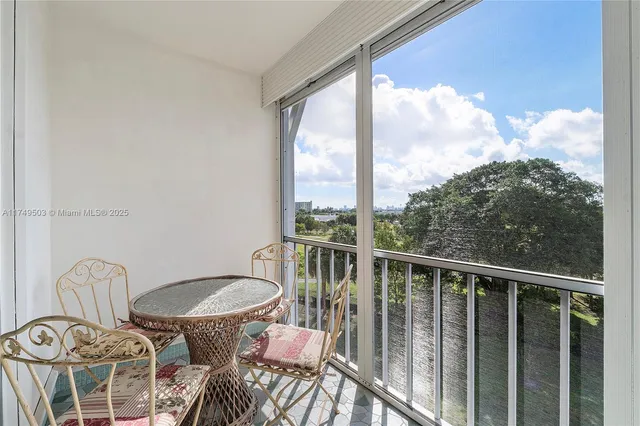 a view of a balcony with chair and glass door