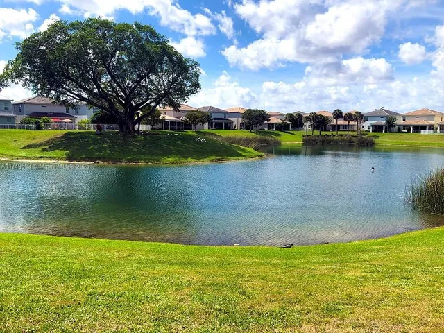 a view of a lake with houses in the background