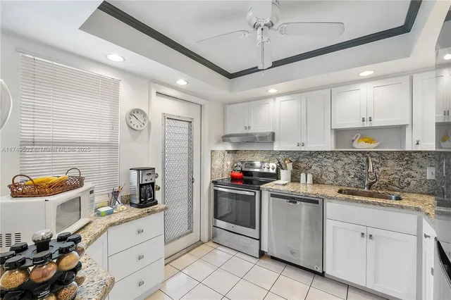 a kitchen with stainless steel appliances granite countertop a sink and cabinets
