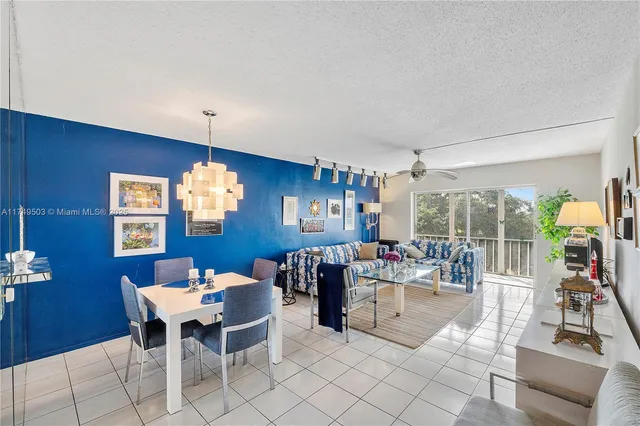 a dining room with furniture a rug and a chandelier