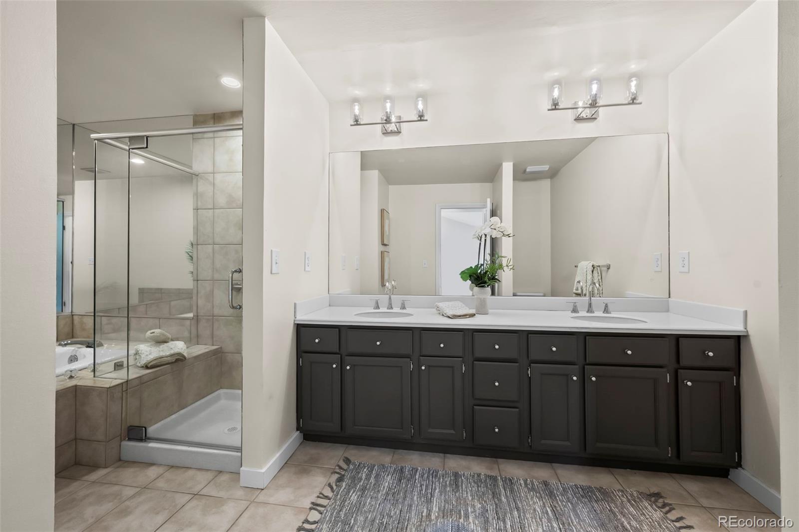 7264 Siena Way, Unit C Boulder, CO 80301 - Photo 30 of 48 a spacious bathroom with a double vanity sink a mirror and a bathtub