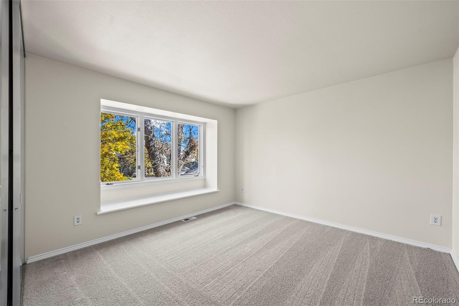 7264 Siena Way, Unit C Boulder, CO 80301 - Photo 33 of 48 an empty room with windows and painting on the wall