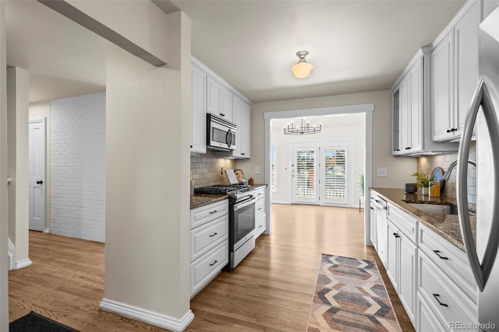 7264 Siena Way, Unit C Boulder, CO 80301 - Photo 7 of 48 a large kitchen with stainless steel appliances granite countertop a stove and a sink
