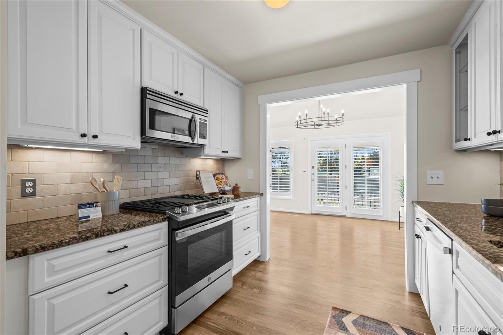 7264 Siena Way, Unit C Boulder, CO 80301 - Photo 9 of 48 a kitchen with granite countertop a stove a sink and a granite counter tops